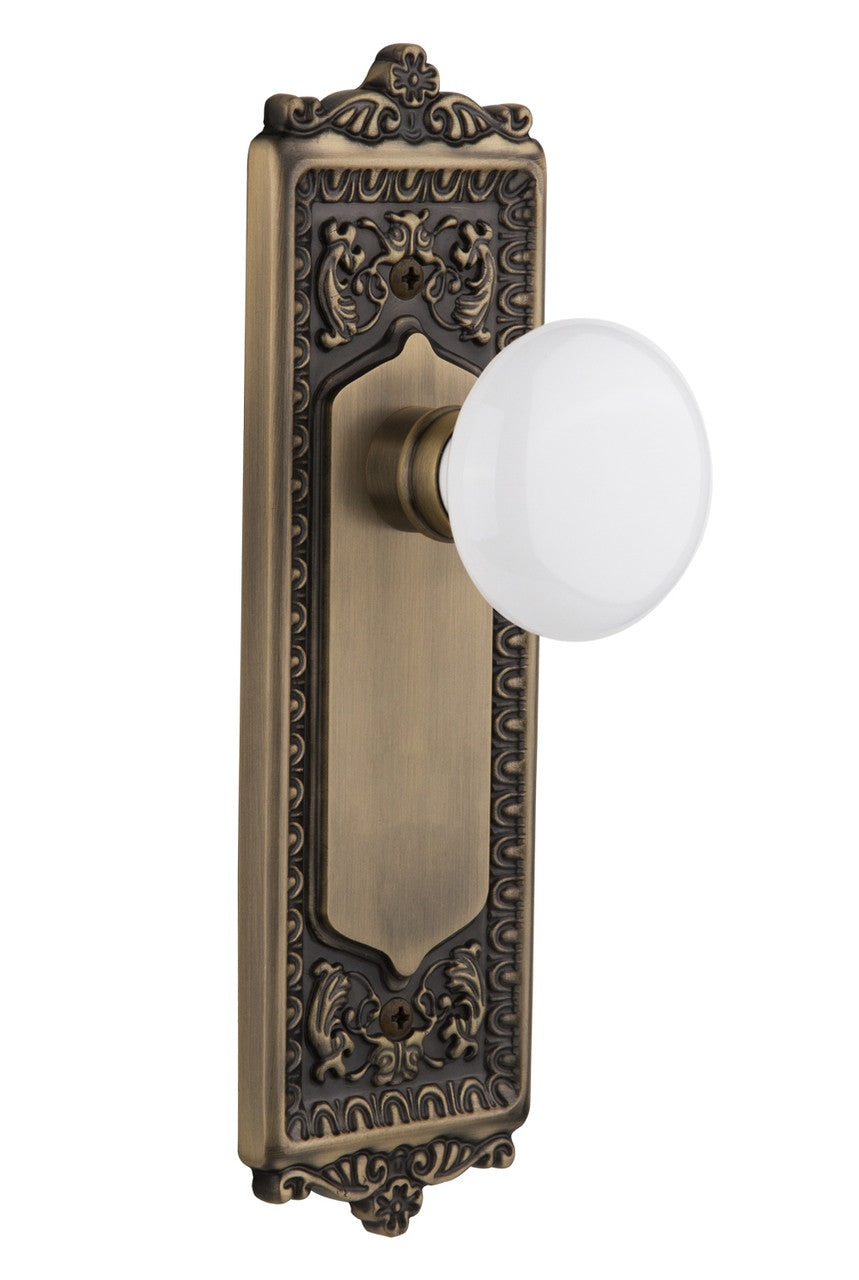 Nostalgic 701996: Egg & Dart Backplate w/White Porcelain Knob Passage Door Set - Antique Brass