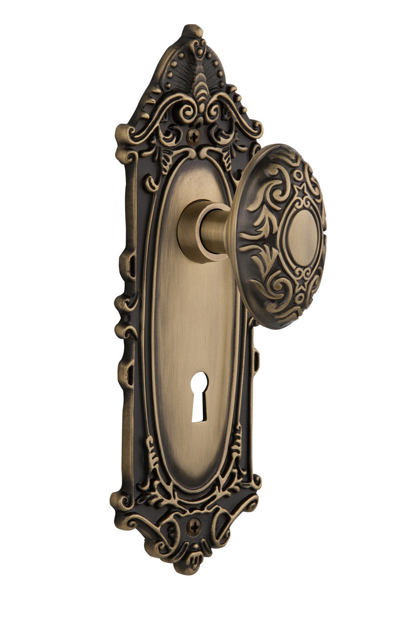Nostalgic 702023: Victorian Backplate w/Victorian Knob Passage Door Set - Antique Brass
