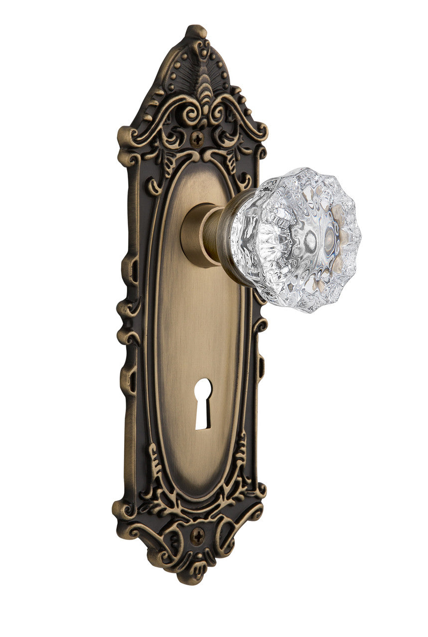 Nostalgic 702090: Victorian Backplate w/Clear Crystal Glass Knob Privacy Door Set - Antique Brass