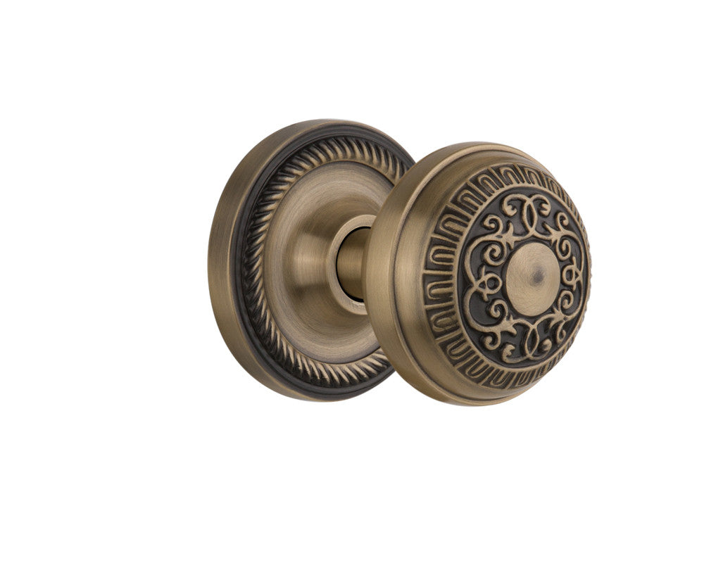 Nostalgic 702555: Rope Rosette w/Egg & Dart Knob Passage Door Set - Antique Brass