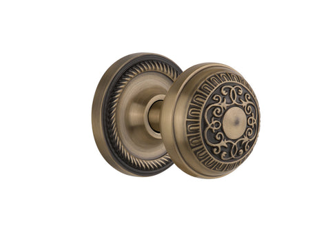 Nostalgic 702555: Rope Rosette w/Egg & Dart Knob Passage Door Set - Antique Brass