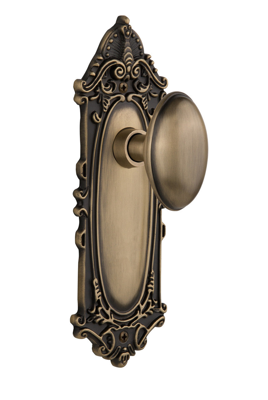 Nostalgic 704004: Victorian Backplate w/Homestead Knob Privacy Door Set - Antique Brass