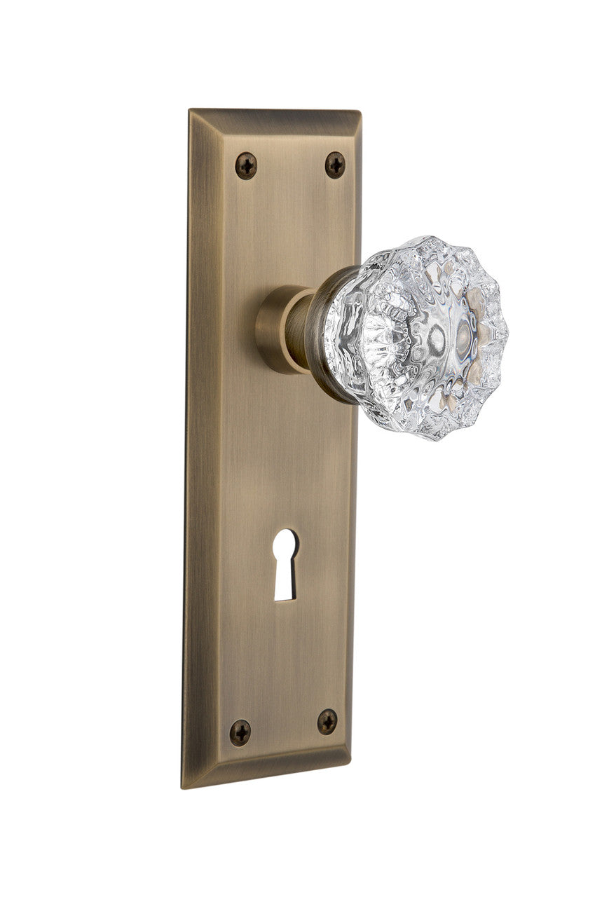 Nostalgic 704564: New York Backplate w/Clear Crystal Glass Knob Passage Door Set - Antique Brass