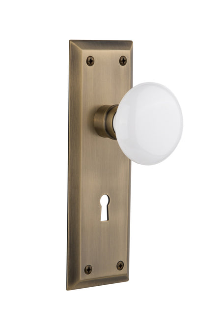 Nostalgic 704635: New York Backplate w/White Porcelain Knob Privacy Door Set - Antique Brass