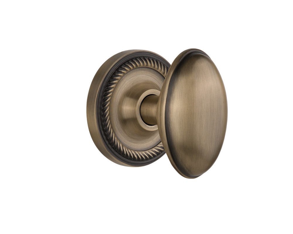 Nostalgic 704672: Rope Rosette w/Homestead Knob Passage Door Set - Antique Brass