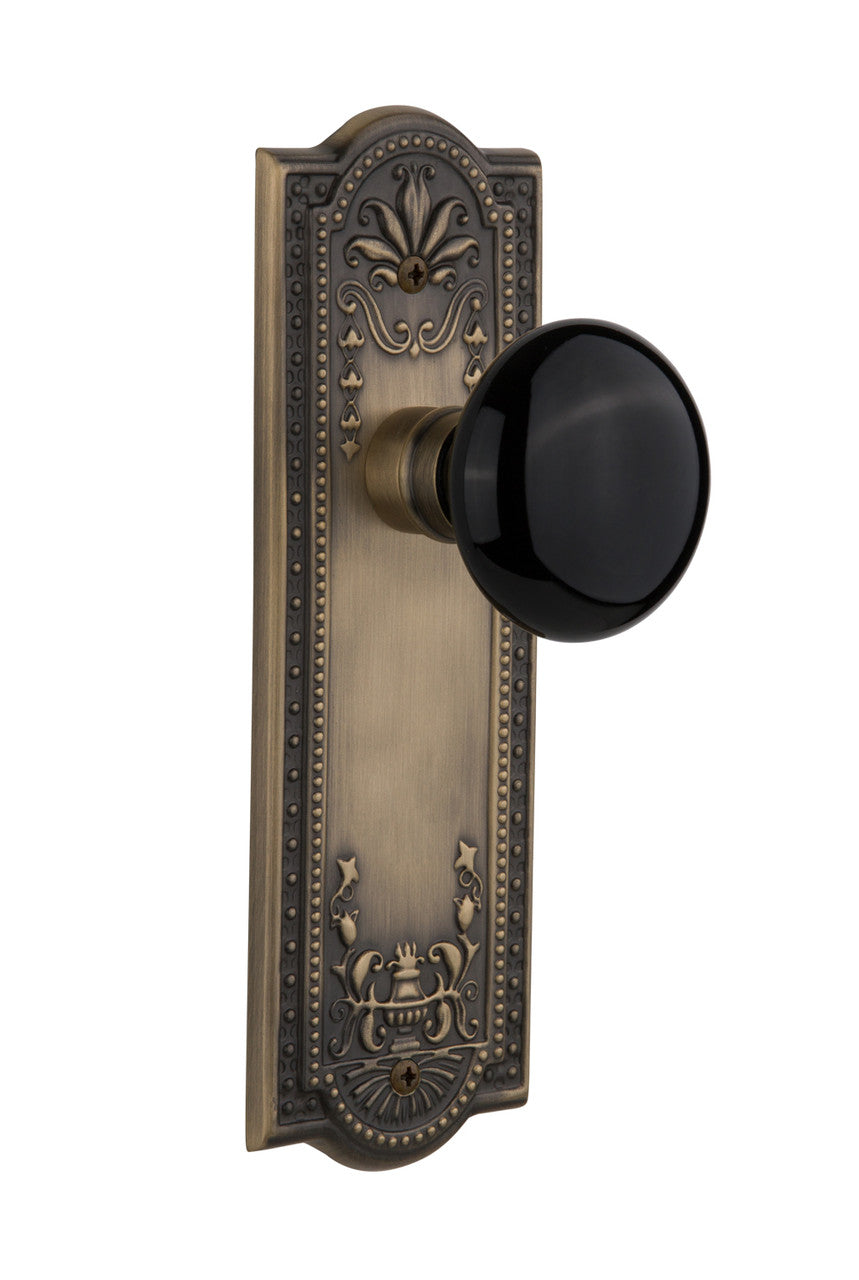 Nostalgic 710014: Meadows Backplate w/Black Porcelain Knob Passage Door Set - Antique Brass