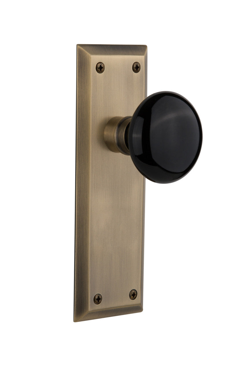 Nostalgic 710117: New York Backplate w/Black Porcelain Knob Single Dummy Door Set - Antique Brass