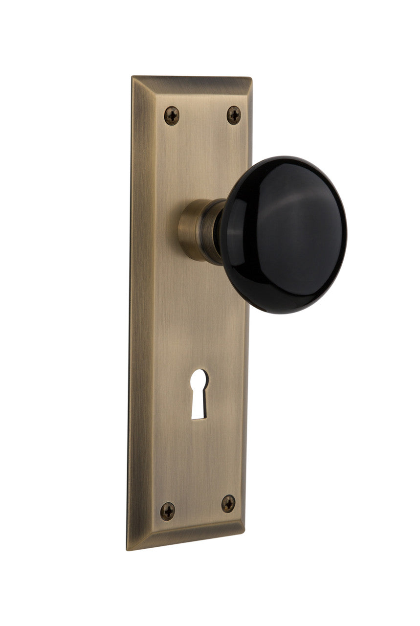 Nostalgic 710171: New York Backplate w/Black Porcelain Knob Single Dummy Door Set - Antique Brass