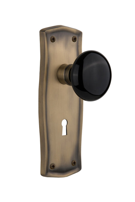 Nostalgic 710178: Prairie Backplate w/Black Porcelain Knob Single Dummy Door Set - Antique Brass