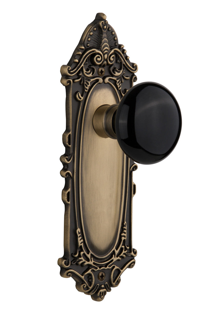 Nostalgic 710323: Victorian Backplate w/Black Porcelain Knob Privacy Door Set - Antique Brass