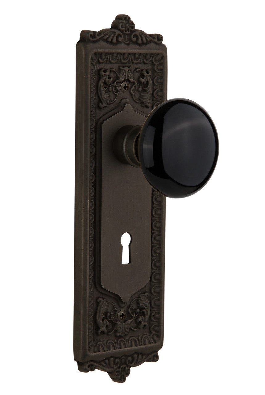 Nostalgic 710352: Egg & Dart Backplate w/Black Porcelain Knob Privacy Door Set - Oil-Rubbed Bronze