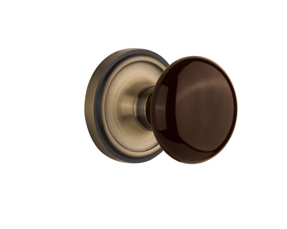 Nostalgic 710440: Classic Rosette w/Brown Porcelain Knob Passage Door Set - Antique Brass