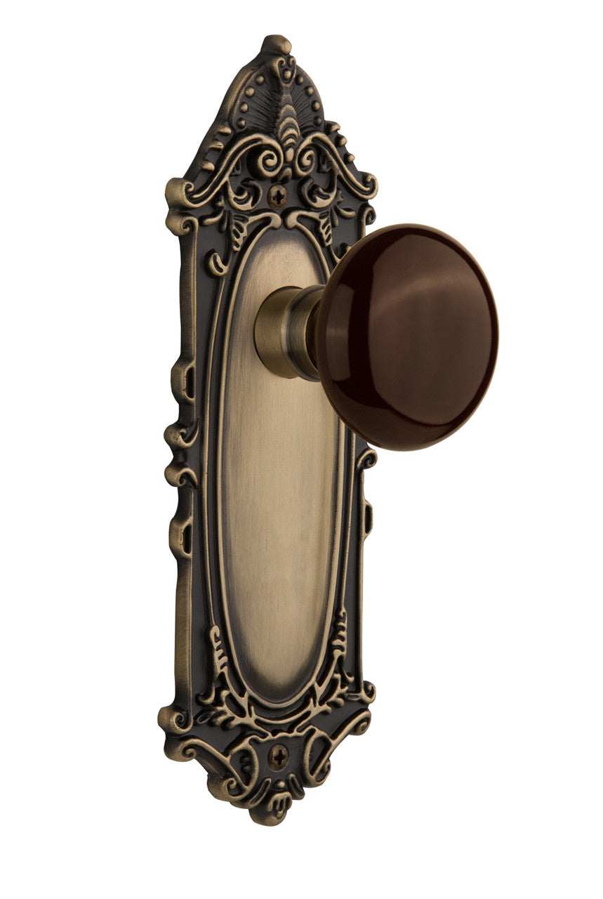 Nostalgic 710475: Victorian Backplate w/Brown Porcelain Knob Passage Door Set - Antique Brass