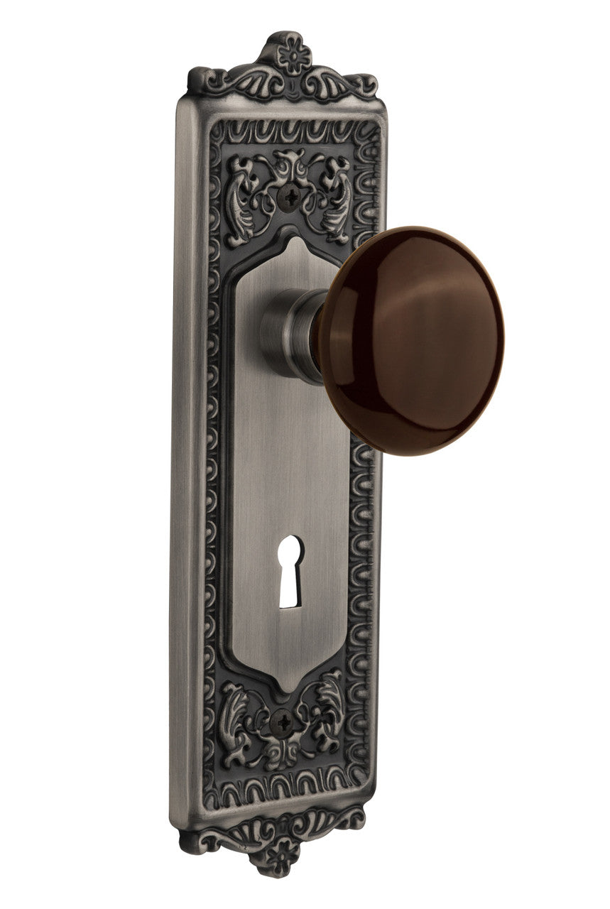 Nostalgic 710502: Egg & Dart Backplate w/Brown Porcelain Knob Passage Door Set - Antique Pewter