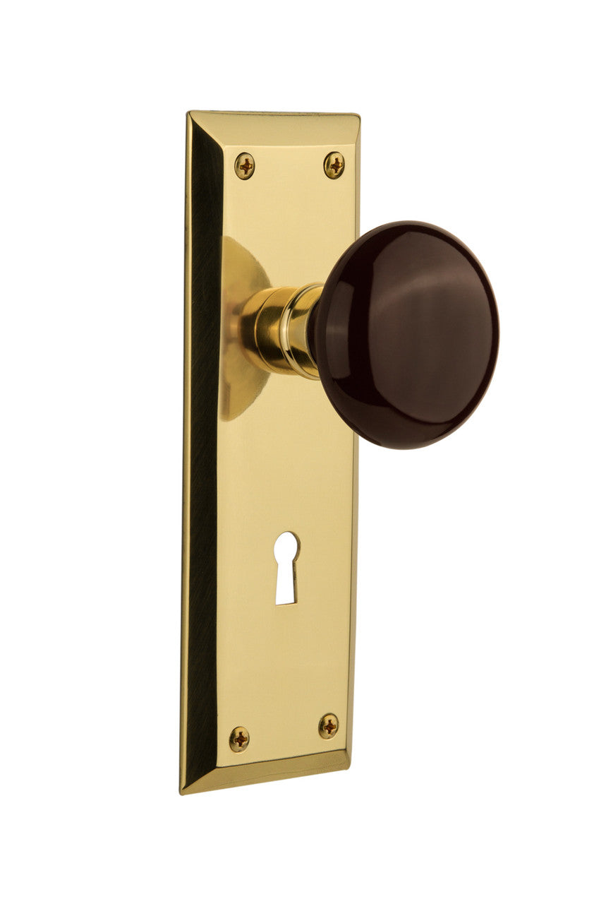 Nostalgic 710519: New York Backplate w/Brown Porcelain Knob Passage Door Set - Polished Brass