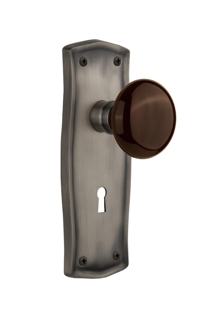 Nostalgic 710523: Prairie Backplate w/Brown Porcelain Knob Passage Door Set - Antique Pewter