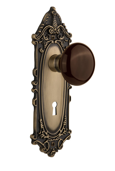 Nostalgic 710529: Victorian Backplate w/Brown Porcelain Knob Passage Door Set - Antique Brass