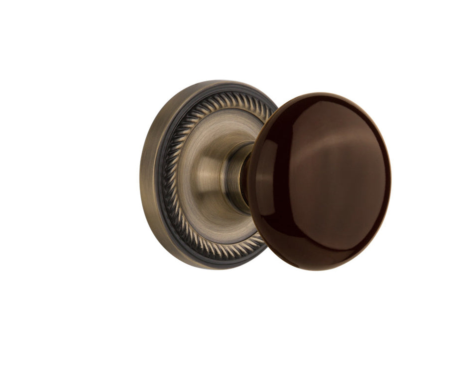 Nostalgic 710756: Rope Rosette w/Brown Porcelain Knob Privacy Door Set - Antique Brass