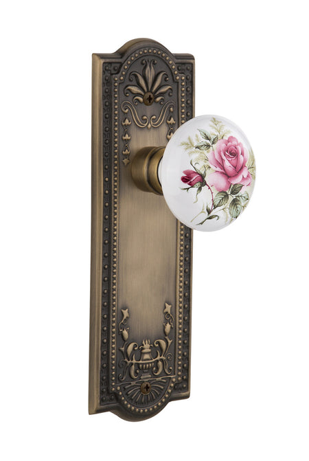 Nostalgic 710894: Meadows Backplate w/White Rose Porcelain Knob Passage Door Set - Antique Brass