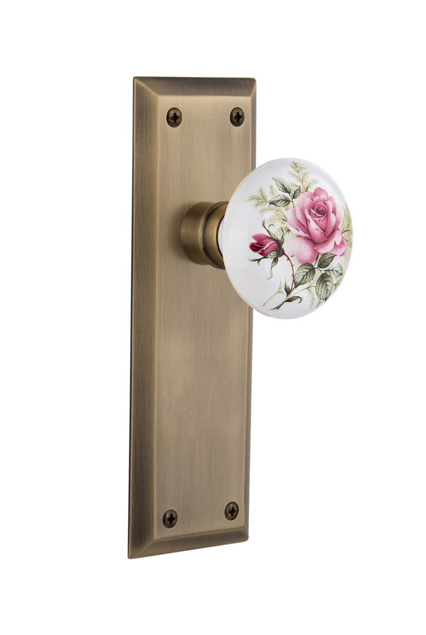 Nostalgic 710901: New York Backplate w/White Rose Porcelain Knob Passage Door Set - Antique Brass