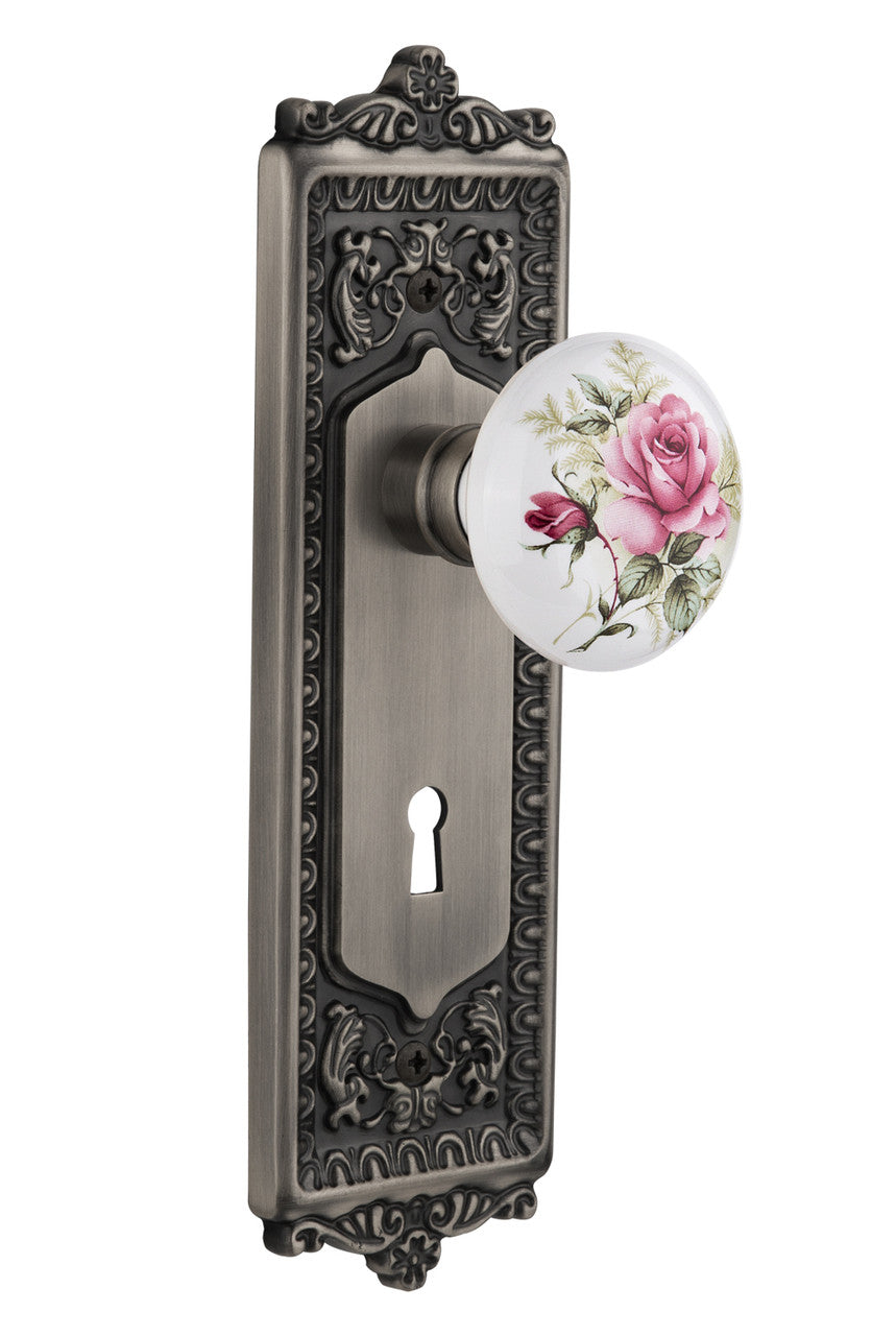 Nostalgic 710942: Egg & Dart Backplate w/White Rose Porcelain Knob Passage Door Set - Antique Pewter