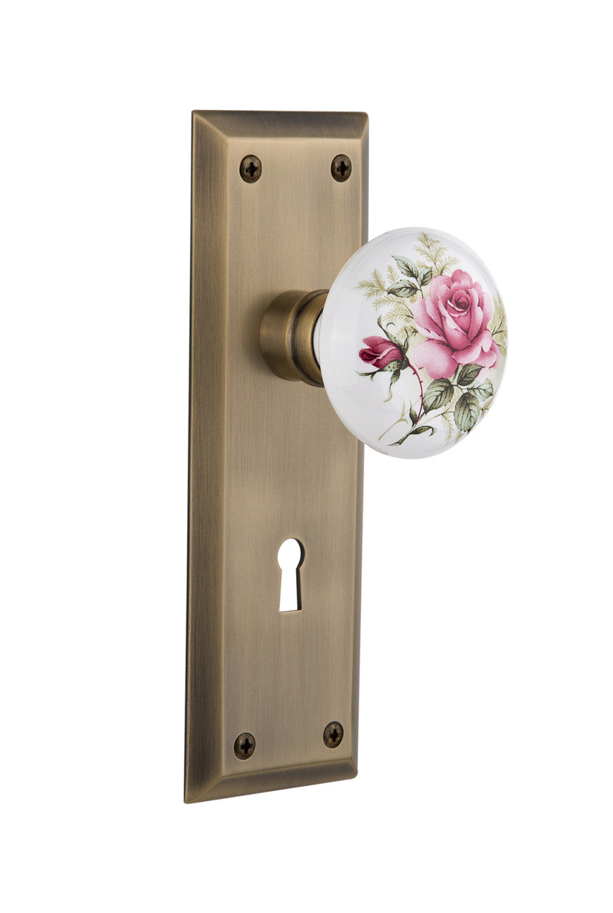 Nostalgic 711051: New York Backplate w/White Rose Porcelain Knob Single Dummy Door Set - Antique Brass