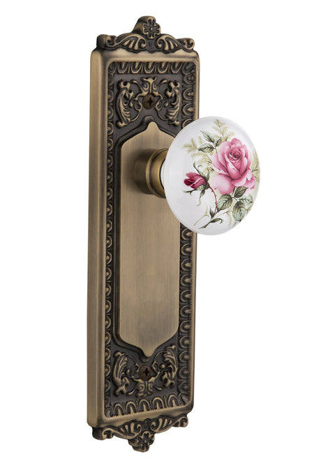 Nostalgic 711175: Egg & Dart Backplate w/White Rose Porcelain Knob Privacy Door Set - Antique Brass