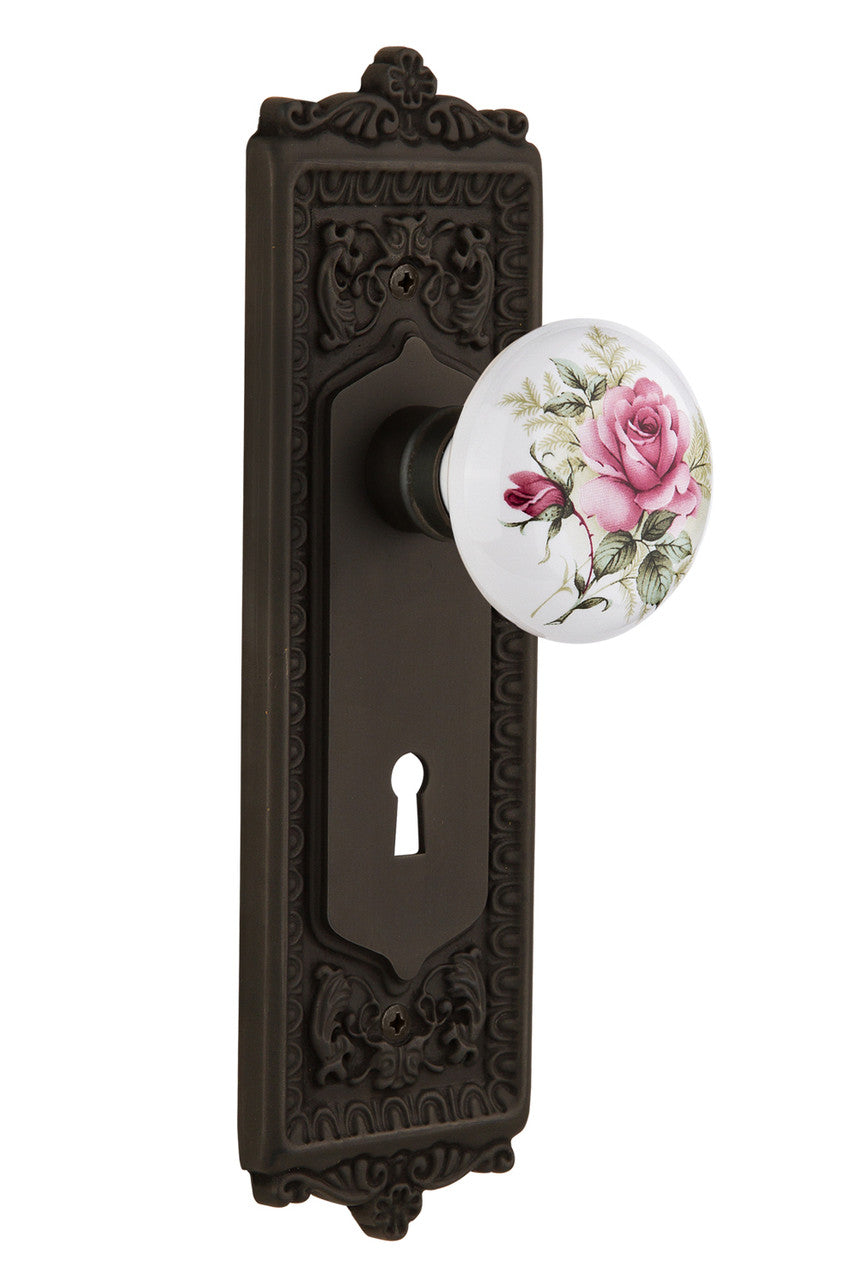 Nostalgic 711232: Egg & Dart Backplate w/White Rose Porcelain Knob Privacy Door Set - Oil-Rubbed Bronze