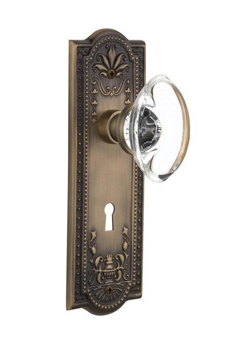 Nostalgic 711388: Meadows Backplate w/Oval Clear Glass Crystal Knob Passage Door Set - Antique Brass