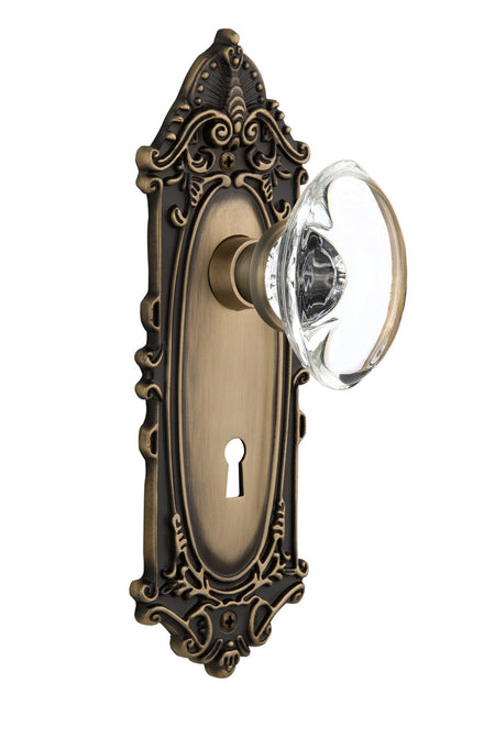 Nostalgic 711409: Victorian Backplate w/Oval Clear Glass Crystal Knob Passage Door Set - Antique Brass