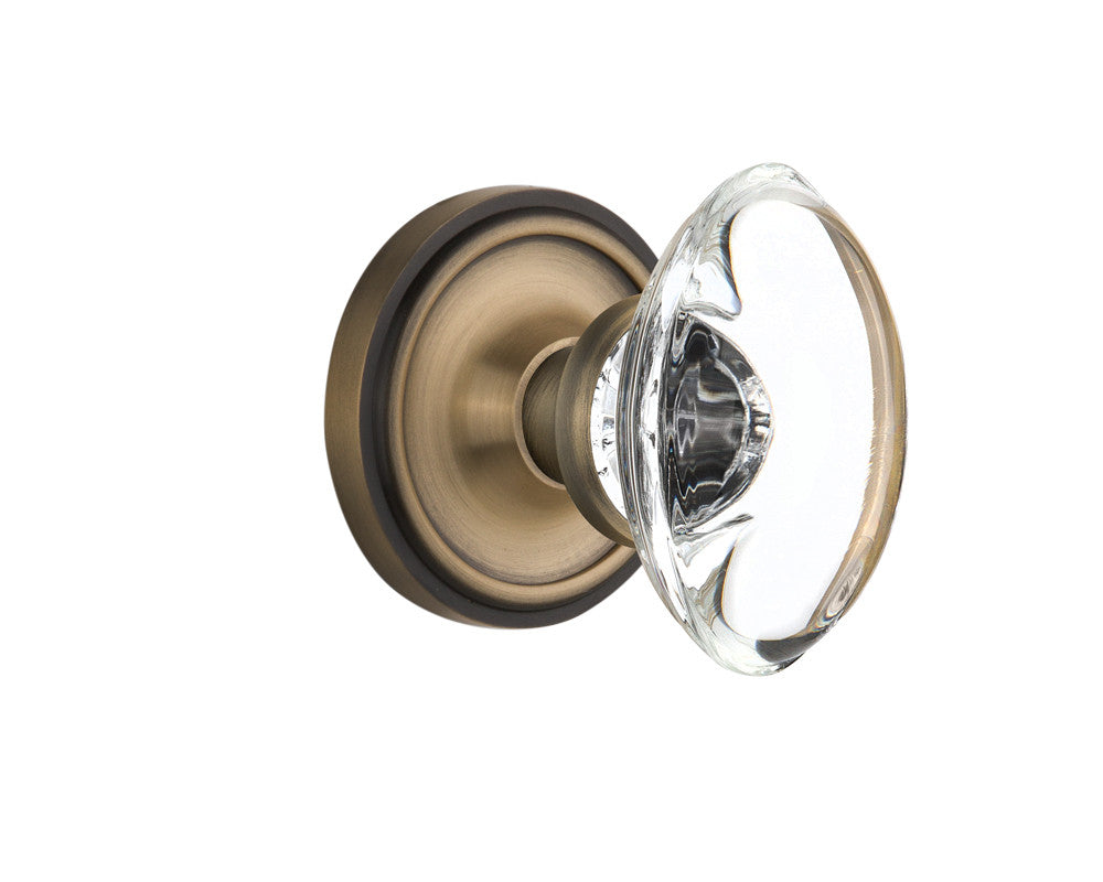 Nostalgic 711608: Classic Rosette w/Oval Clear Glass Crystal Knob Privacy Door Set - Antique Brass
