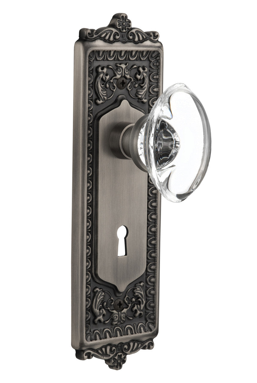 Nostalgic 711670: Egg & Dart Backplate w/Oval Clear Glass Crystal Knob Privacy Door Set - Antique Pewter