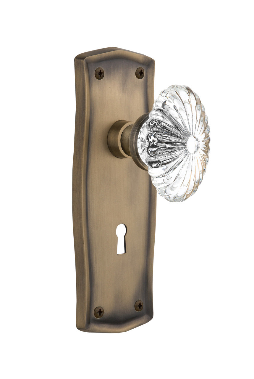Nostalgic 711842: Prairie Backplate w/Oval Fluted Clear Glass Crystal Knob Passage Door Set - Antique Brass