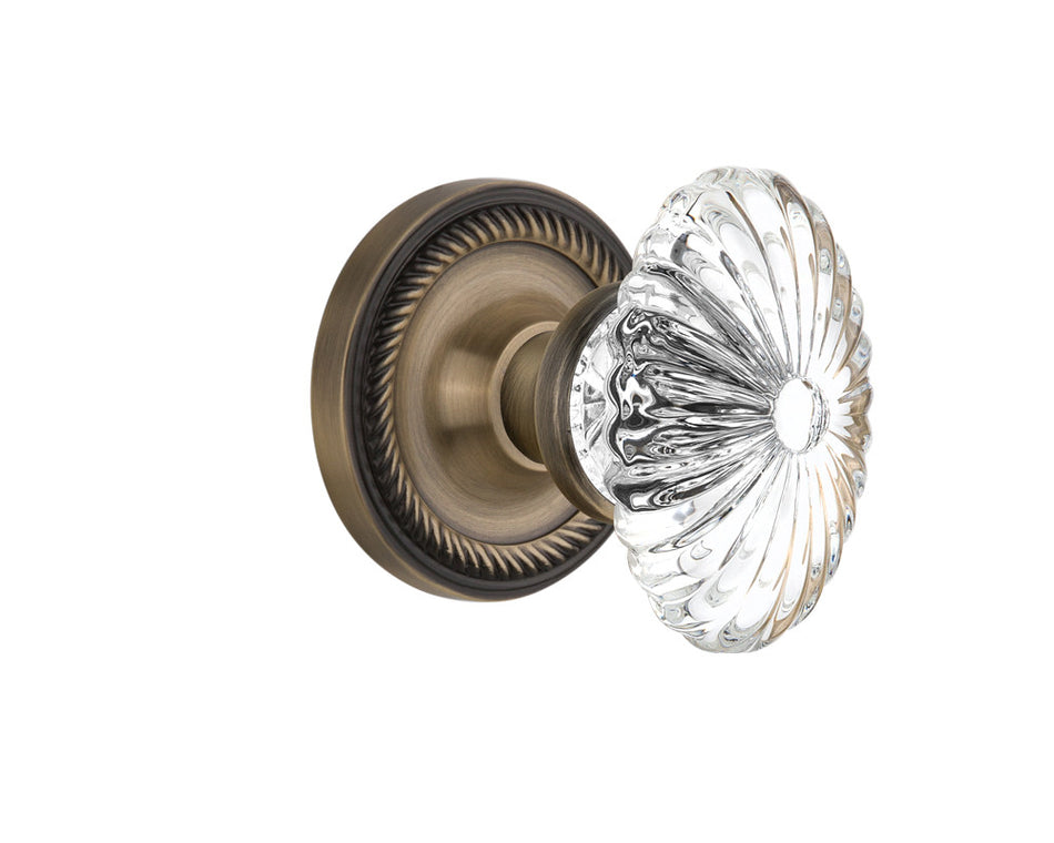 Nostalgic 712076: Rope Rosette w/Oval Fluted Clear Glass Crystal Knob Privacy Door Set - Antique Brass