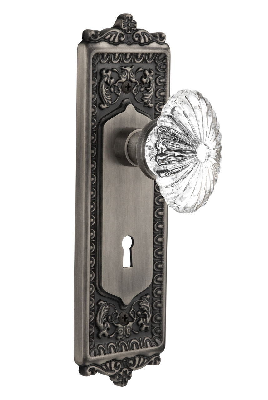 Nostalgic 712110: Egg & Dart Backplate w/Oval Fluted Clear Glass Crystal Knob Privacy Door Set - Antique Pewter
