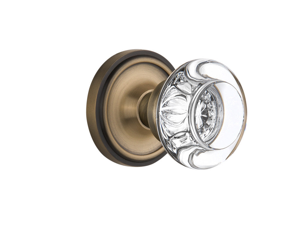 Nostalgic 712200: Classic Rosette w/Round Clear Glass Crystal Knob Passage Door Set - Antique Brass