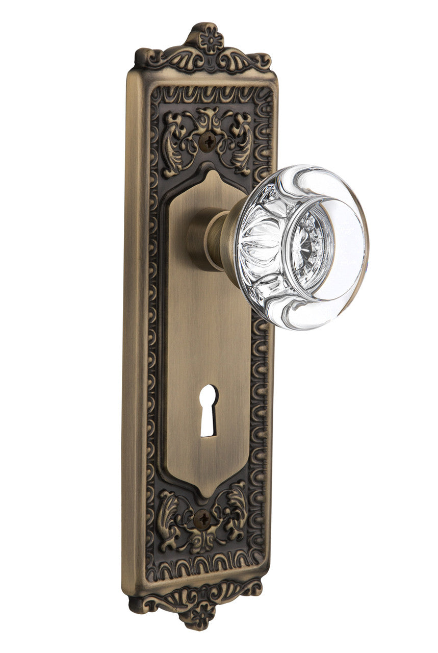 Nostalgic 712261: Egg & Dart Backplate w/Round Clear Glass Crystal Knob Passage Door Set - Antique Brass
