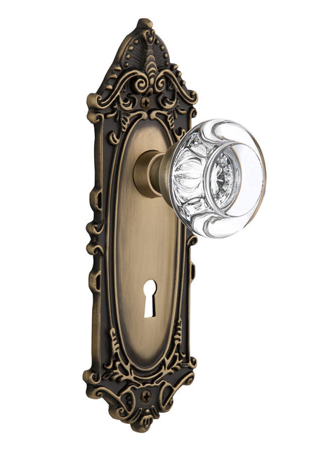 Nostalgic 712289: Victorian Backplate w/Round Clear Glass Crystal Knob Passage Door Set - Antique Brass