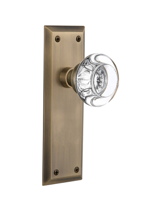 Nostalgic 712509: New York Backplate w/Round Clear Glass Crystal Knob Privacy Door Set - Antique Brass