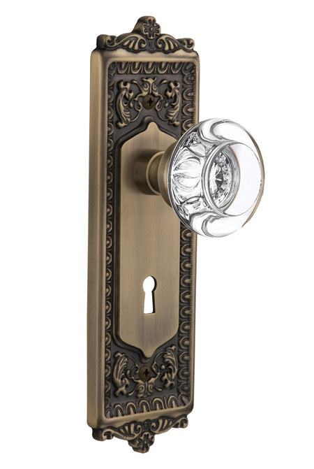 Nostalgic 712549: Egg & Dart Backplate w/Round Clear Glass Crystal Knob Privacy Door Set - Antique Brass