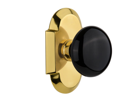 Nostalgic 712879: Cottage Backplate w/Black Porcelain Knob Passage Door Set - Polished Brass