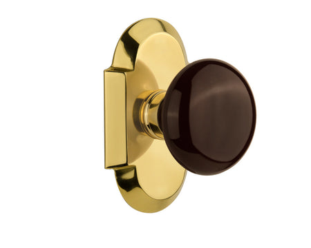 Nostalgic 712886: Cottage Backplate w/Brown Porcelain Knob Passage Door Set - Polished Brass