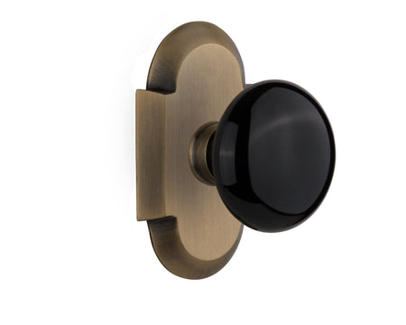 Nostalgic 713067: Cottage Backplate w/Black Porcelain Knob Single Dummy Door Set - Antique Brass