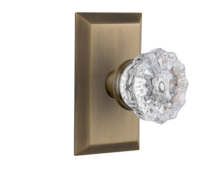 Nostalgic 713208: Studio Backplate w/Clear Crystal Glass Knob Passage Door Set - Antique Brass