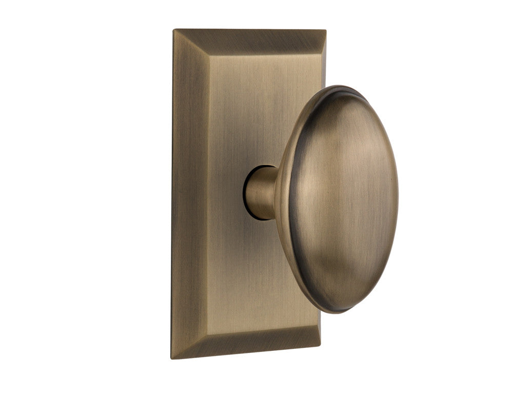 Nostalgic 713222: Studio Backplate w/Homestead Knob Passage Door Set - Antique Brass