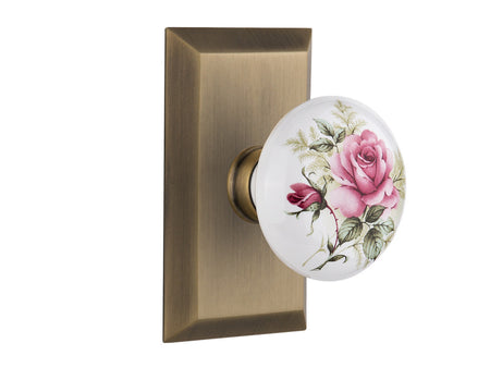 Nostalgic 713263: Studio Backplate w/White Rose Porcelain Knob Passage Door Set - Antique Brass