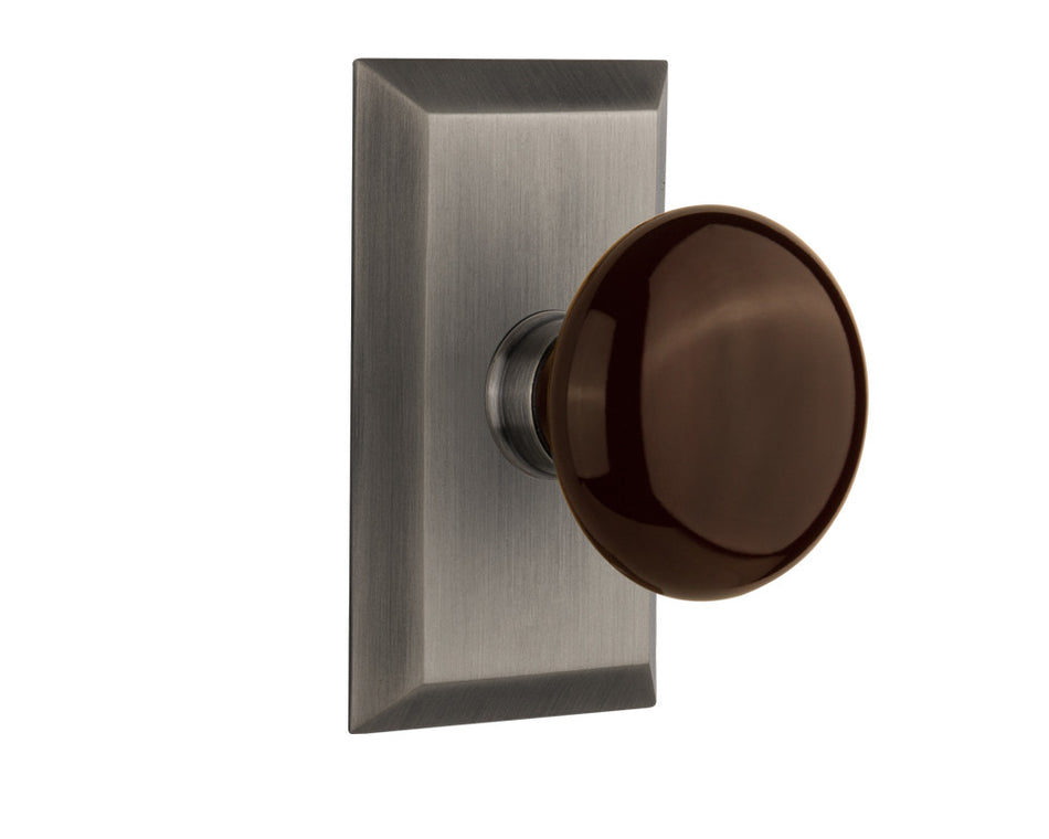 Nostalgic 713291: Studio Backplate w/Brown Porcelain Knob Passage Door Set - Antique Pewter