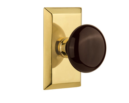 Nostalgic 713294: Studio Backplate w/Brown Porcelain Knob Passage Door Set - Polished Brass