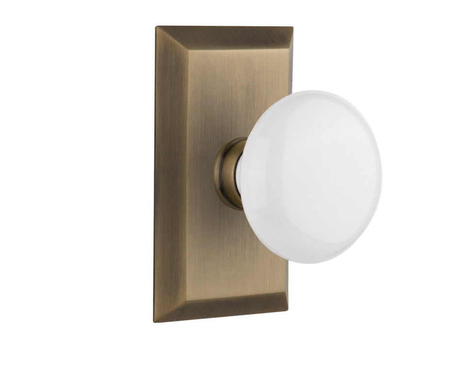 Nostalgic 713297: Studio Backplate w/White Porcelain Knob Passage Door Set - Antique Brass