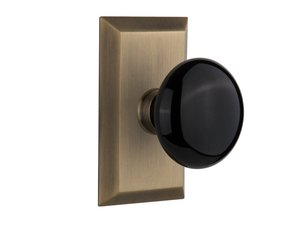 Nostalgic 713379: Studio Backplate w/Black Porcelain Knob Privacy Door Set - Antique Brass